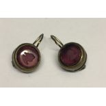 A pair of Victorian earrings with Intaglio carved amethyst coloured stones.