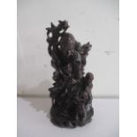 An oriental carved wooden figure of deity A/F