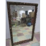 An antique rectangular mirror with swag style decoration