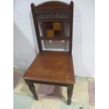 A Gothic hall chair with inset tile to back