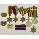 A collection of six WWII medals and three cap badges.