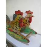 A vintage wooden child's rocking chair in the form of a chicken