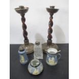 A pair of oak barley twist candlesticks with hallmarked silver sconces and bases along with a