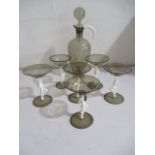 A Birini glass cocktail set, the six glasses each held on stems formed of opaque nude ladies, the
