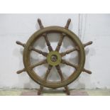 A large ships wheel with brass mounts