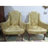 A pair of Queen Anne style armchairs with deep scalloped cabriole legs