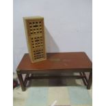 A coffee table with brass trim along with a modern chest of three drawers