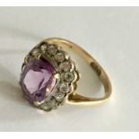 AN amethyst and CZ cluster ring set in 9ct gold.