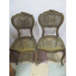A pair of 19th century gilt bedroom chairs with cane seats
