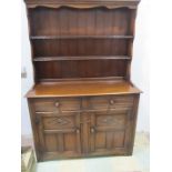 An oak dresser with two drawers and cupboards under