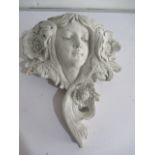 A concrete Art Nouveau style wall pocket