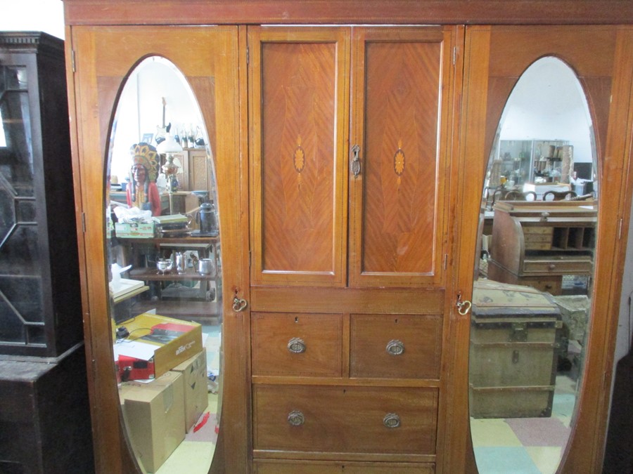 An Edwardian compactum with two mirrored doors, cupboard and drawers under