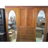 An Edwardian compactum with two mirrored doors, cupboard and drawers under