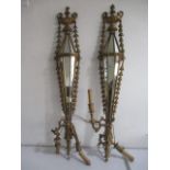 A pair of carved gilt wood mirrored two branch wall sconces each with two handled urn shaped