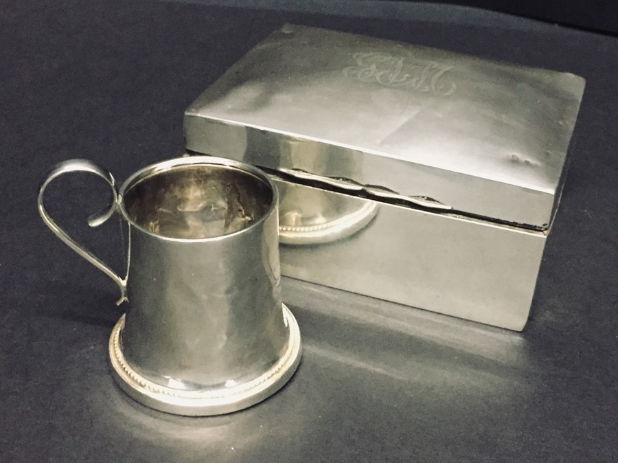 A hallmarked silver cigarette box and miniature tankard.