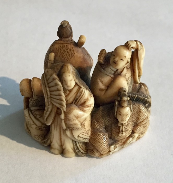 Two ivory Netsukes, one depicting a man holding a staff- signature to underside, along with a - Image 2 of 11