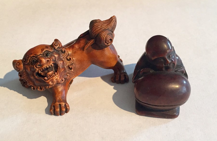 A boxwood Netsuke carved as a dragon, signature to underside along with one other of a kneeling man