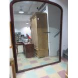 A large Victorian oval mantle mirror, possibly retail display.