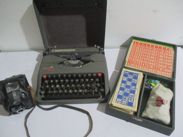 An Empire Aristocrat portable typewriter along with a vintage Lotto game and Ensign Full-Vue camera