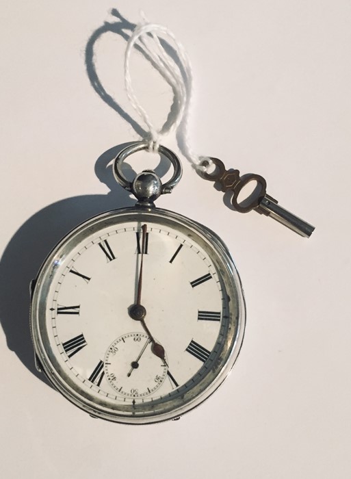 A hallmarked silver pocket watch with key