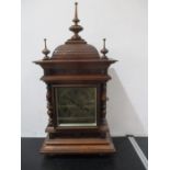 An oak bracket clock with brass face- key in office