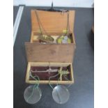 Two wooden cased sets of apothecary scales
