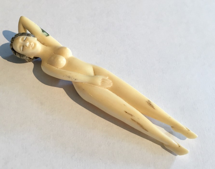 A 19th century ivory Netsuke of a female nude figure, signature to reverse