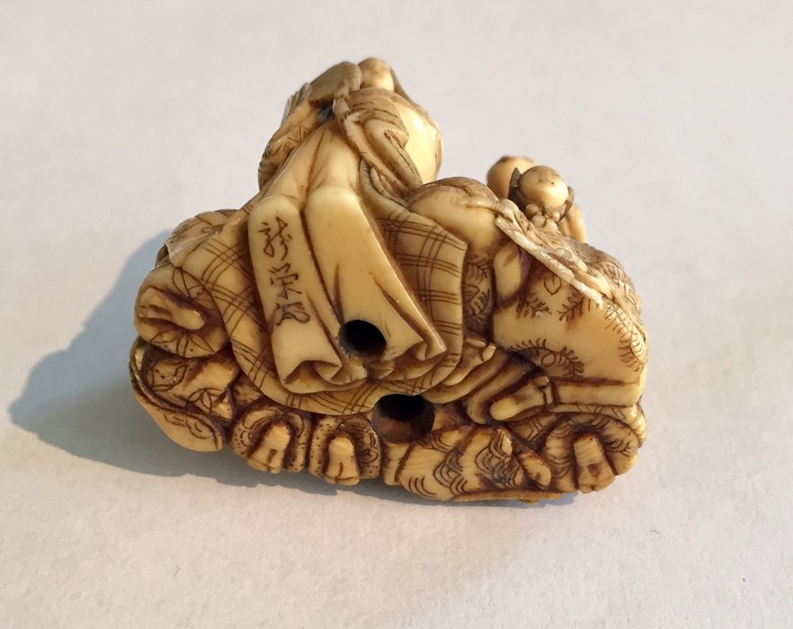 Two ivory Netsukes, one depicting a man holding a staff- signature to underside, along with a - Image 6 of 11