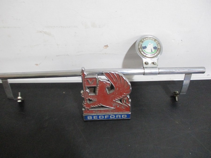 A vintage Caravan Club car badge along with a Bedford car badge