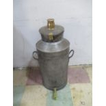 A vintage milk churn with breather top and brass tap.