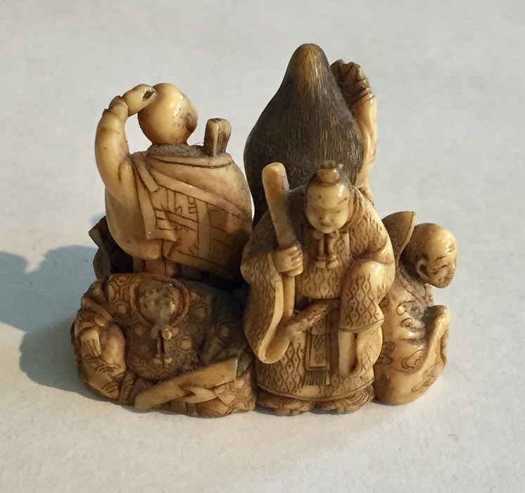 Two ivory Netsukes, one depicting a man holding a staff- signature to underside, along with a - Image 4 of 11