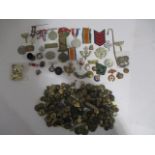 A collection of millitary badges, medals, buttons, cap badges etc