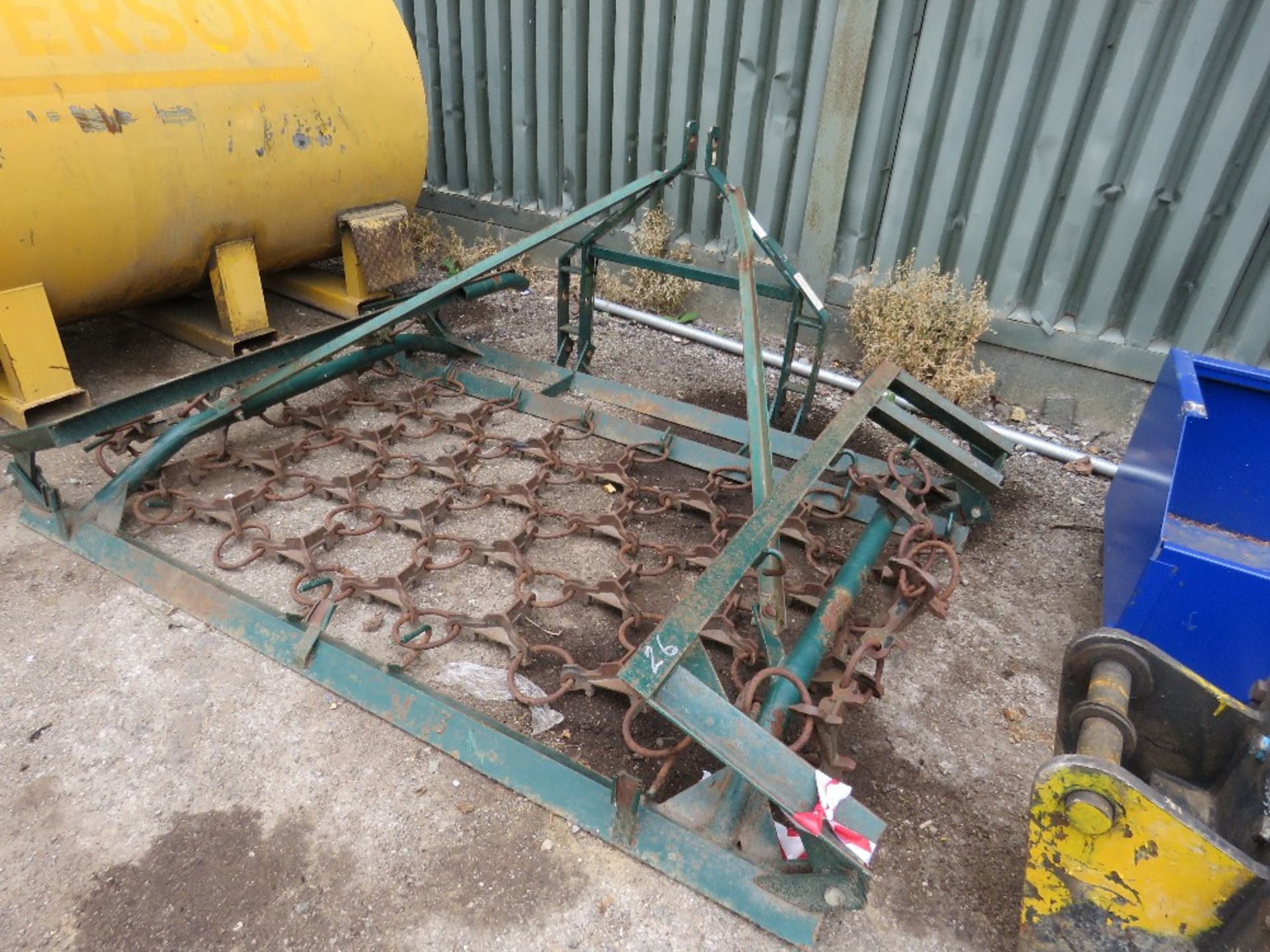 Tractor mounted folding grass harrows