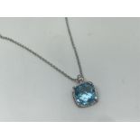 18ct gold blue topaz and diamond pendant and chain.