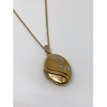 Silver gilt and diamond locket and chain