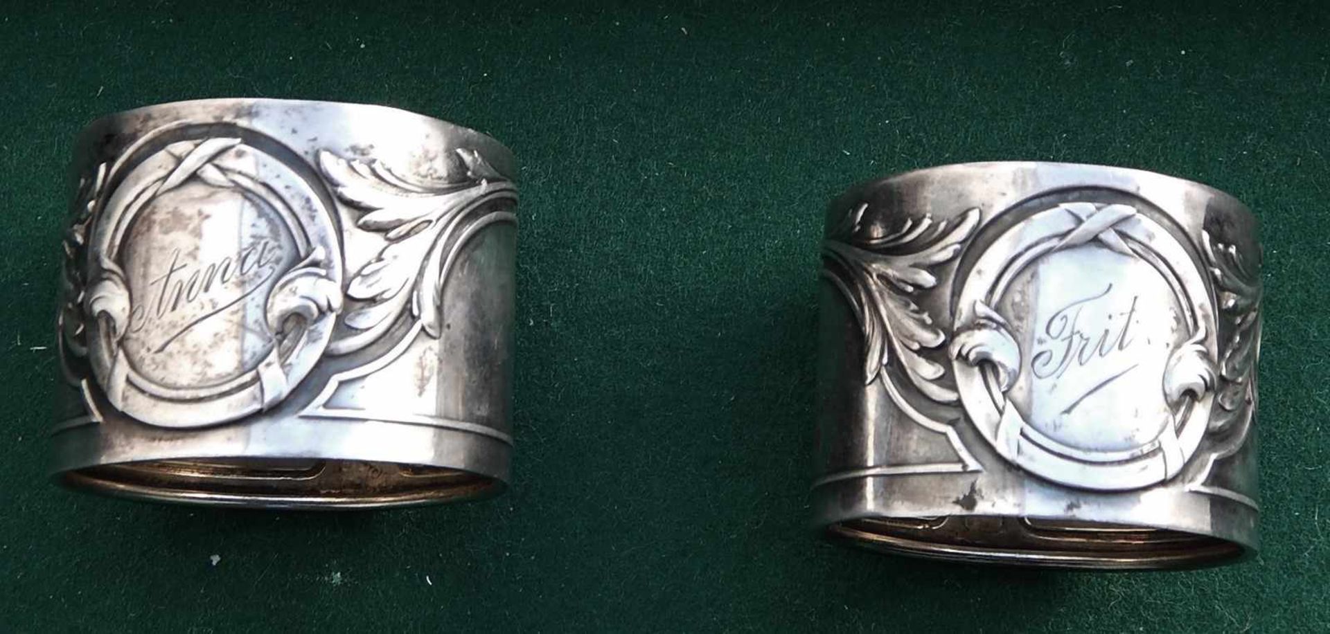 2 Serviettenringe, Jugendstil, bezeichnet "Anna" und "Fritz", 800er Silber, zusammen ca. 43 Gramm
