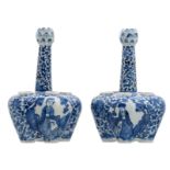 A pair of Chinese blue and white floral and relief decorated tulip vases, the roundels with figures