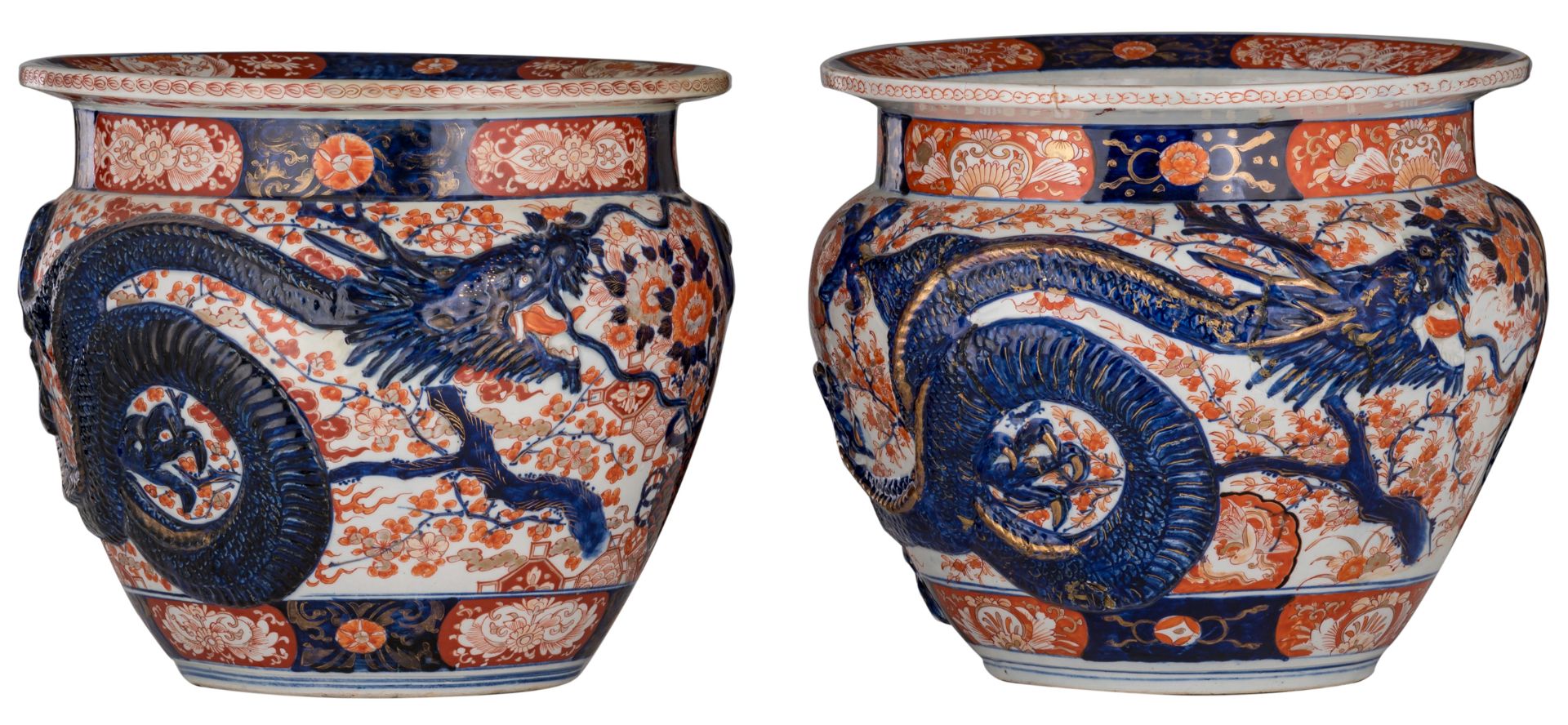 A pair of Japanese Arita Imari fish bowls, relief decorated with flower sprays and a large four claw