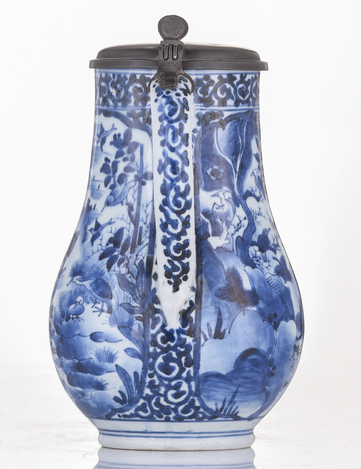 A Japanese Arita Imari blue and white tankard, decorated with scrollwork and panels, filled with fig - Image 3 of 7