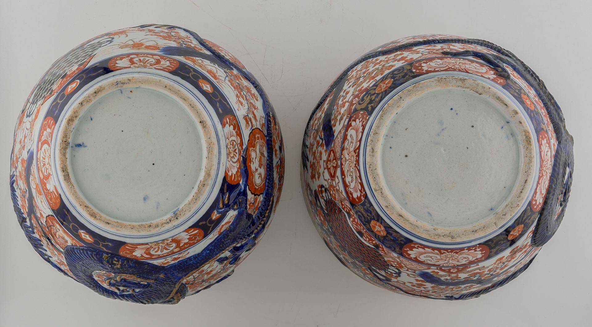 A pair of Japanese Arita Imari fish bowls, relief decorated with flower sprays and a large four claw - Image 7 of 7