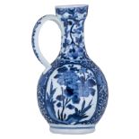 A Japanese last quarter of the 17thC Arita jug, with blue and white scrollwork all over, and roundel