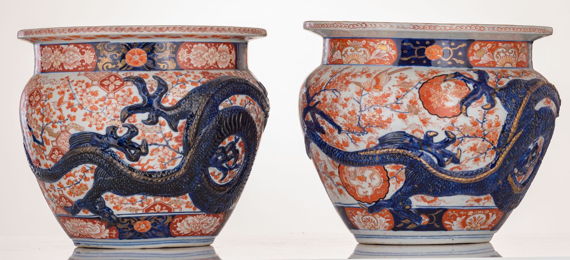 A pair of Japanese Arita Imari fish bowls, relief decorated with flower sprays and a large four claw - Image 5 of 7