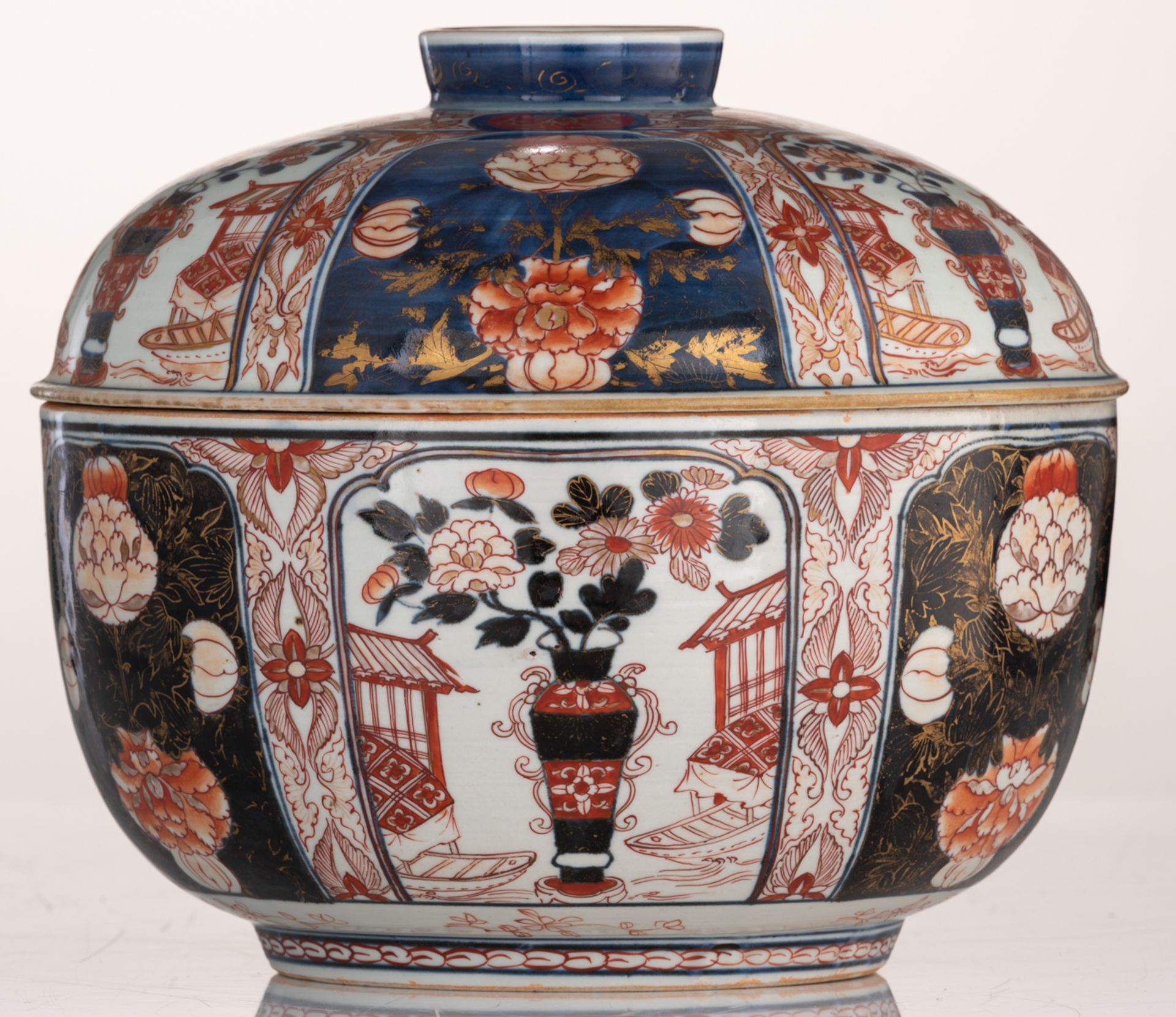 A large Japanese Arita Imari covered bowl, decorated with panels filled with a vase in a garden sett - Image 2 of 7