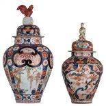 A Japanese Arita Imari covered jar, decorated with flower sprays and with panels, filled with wister