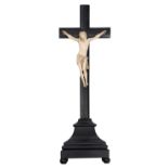 A 19thC ivory Corpus Christi on a wooden ebonised cross, H 25 (the ivory Christ) - 70 cm (the cross)