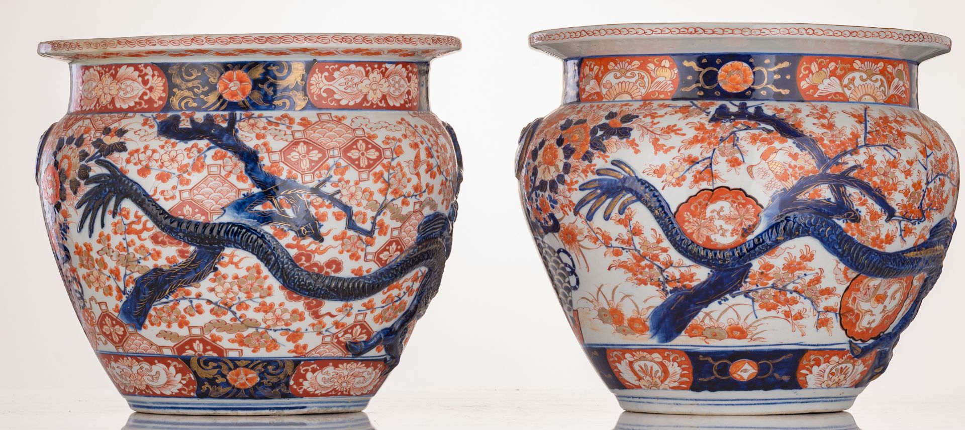 A pair of Japanese Arita Imari fish bowls, relief decorated with flower sprays and a large four claw - Image 4 of 7