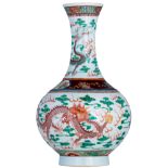 A Chinese famille verte bottle vase, decorated with dragons chasing the flaming pearl, with a Guangx