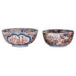 Two large Japanese Arita Imari bowls, one with a five clawed dragon in the centre and borders with a