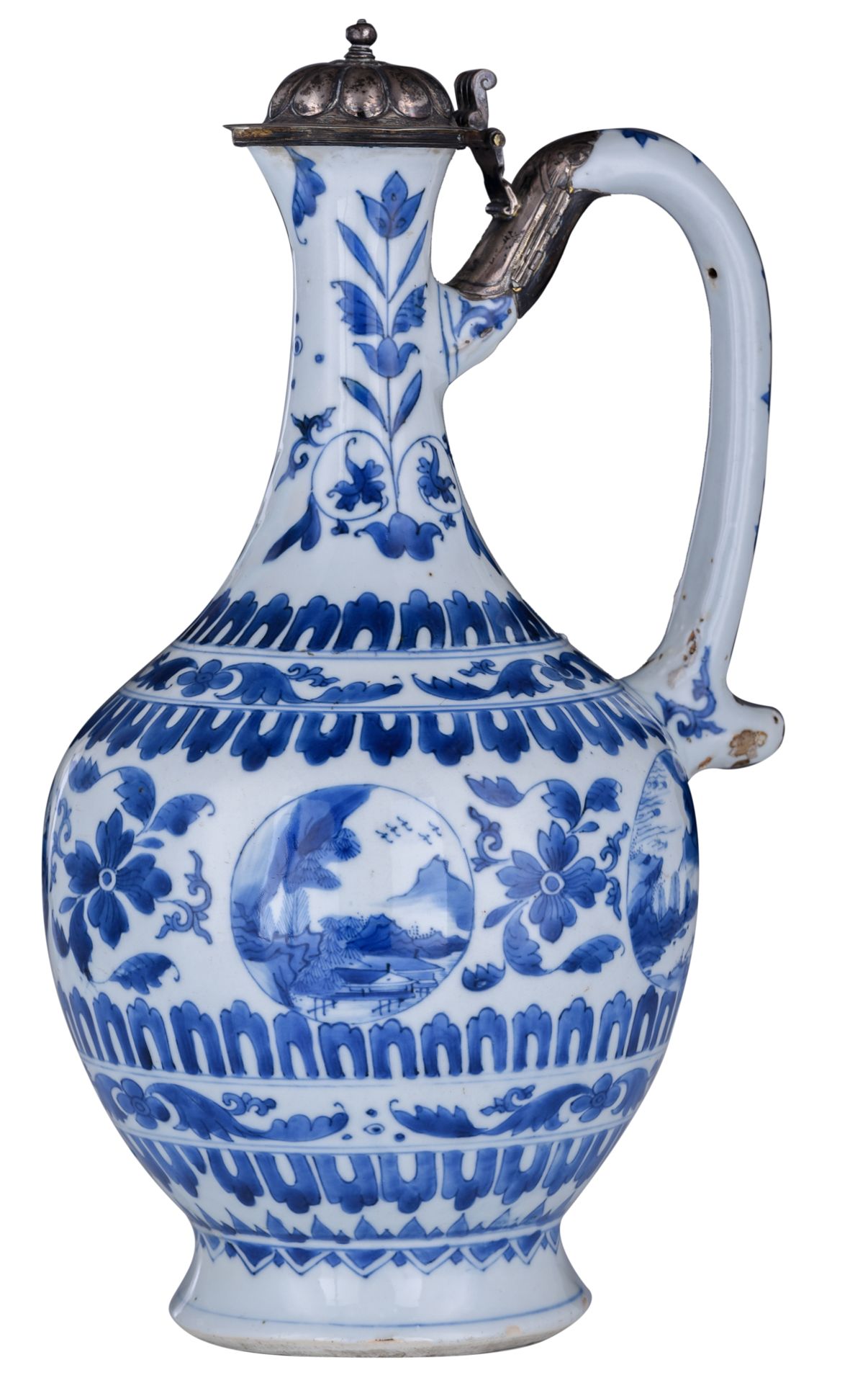 A Chinese blue and white jug with a silver cover, decorated on the neck with a stylised tulip and on