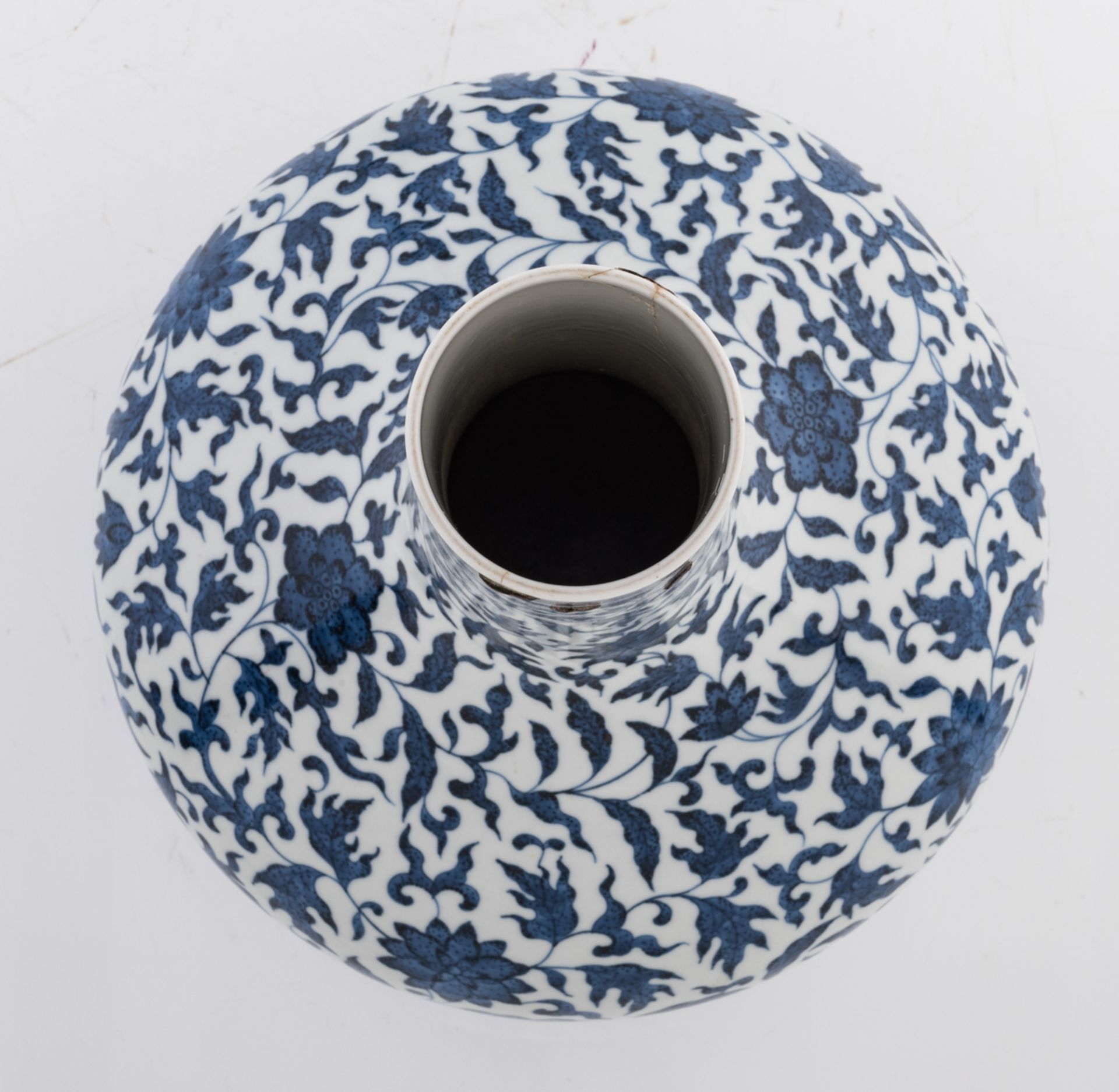 A Chinese blue and white bottle vase, decorated with scrolling leaves, with a Qianlong mark, 19thC, - Image 5 of 6